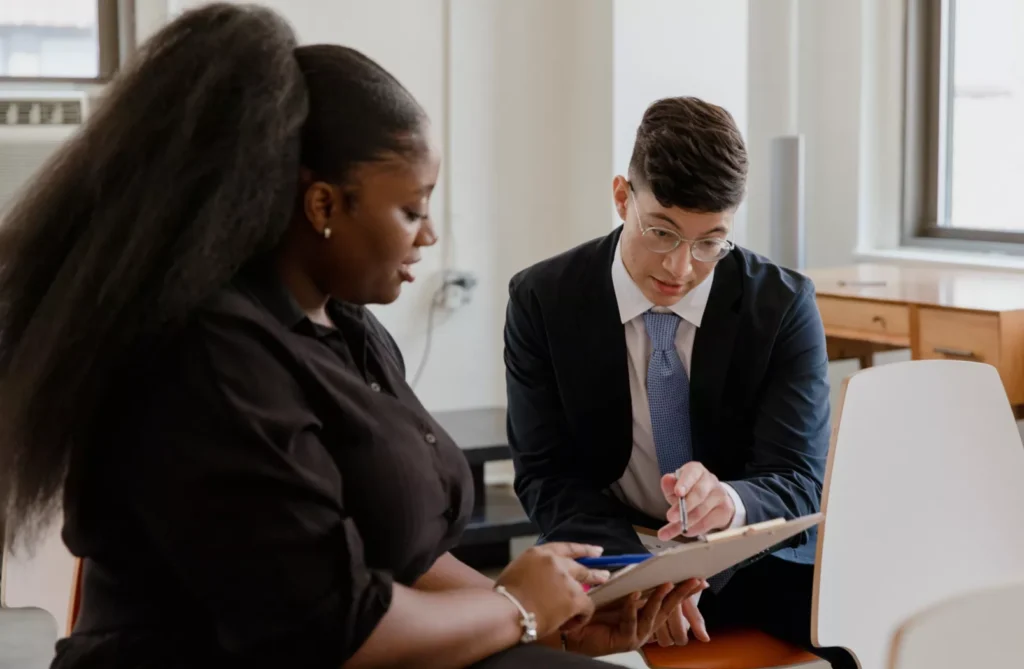 Black woman consulting with a male doctor